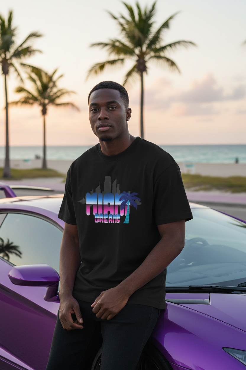 Black male model wearing black Miami Dreams t-shirt next to Lamborghini on Miami beach street